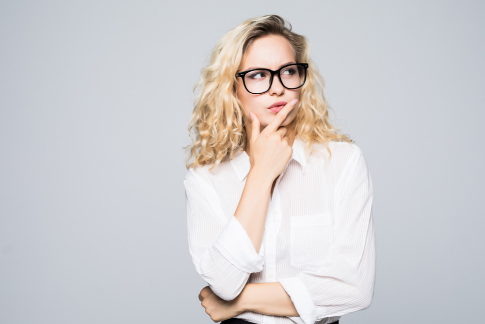 Young female professional thinking about how she can strengthen her interpersonal communication abilities