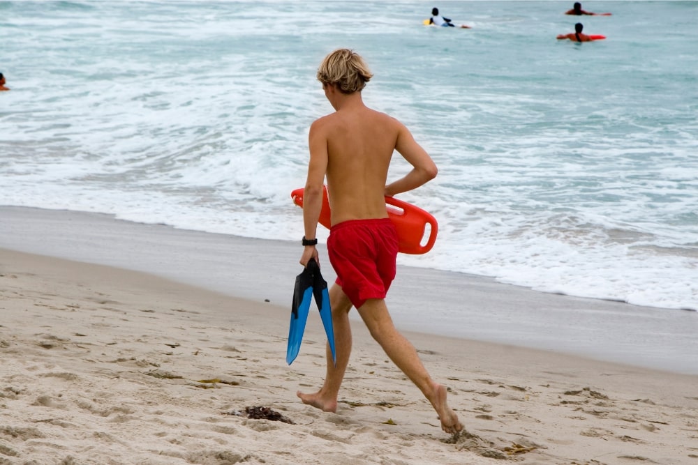 lifeguard running at the beach