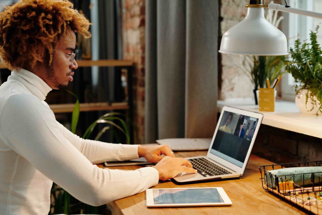 Administrative assistant working from home in virtual meeting with colleagues