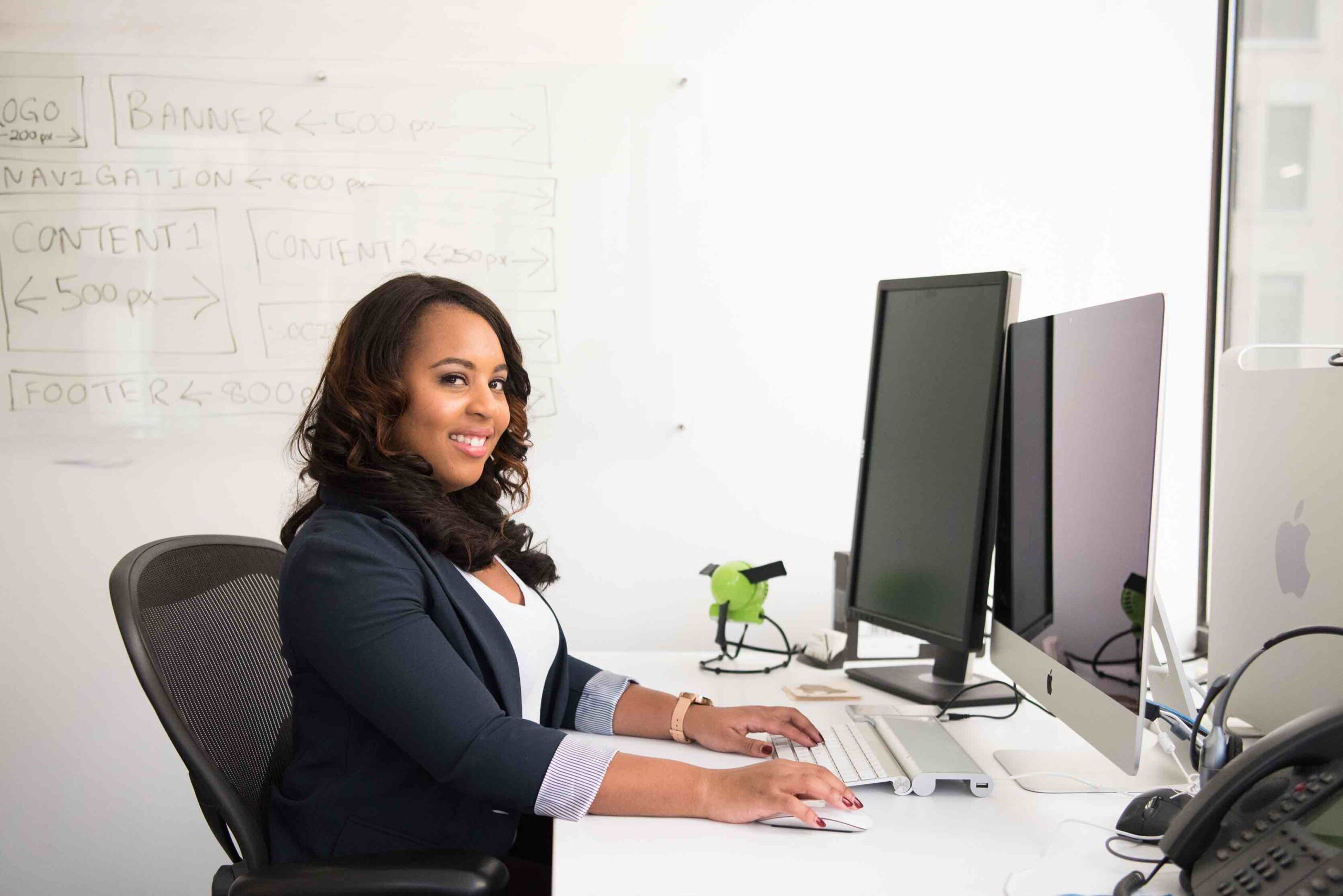 Administrative assistant working on her desk in office