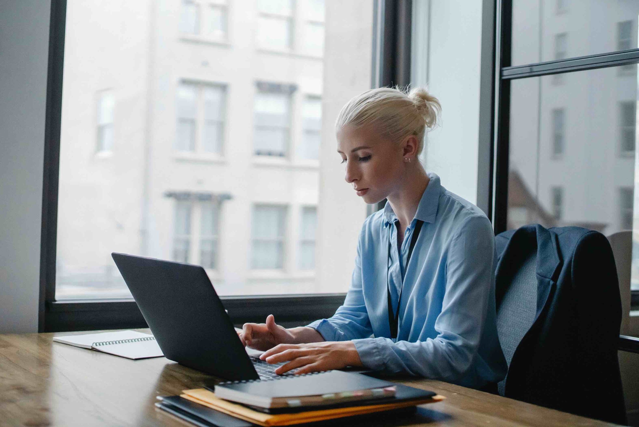 Agile project manager at work typing something into her laptop