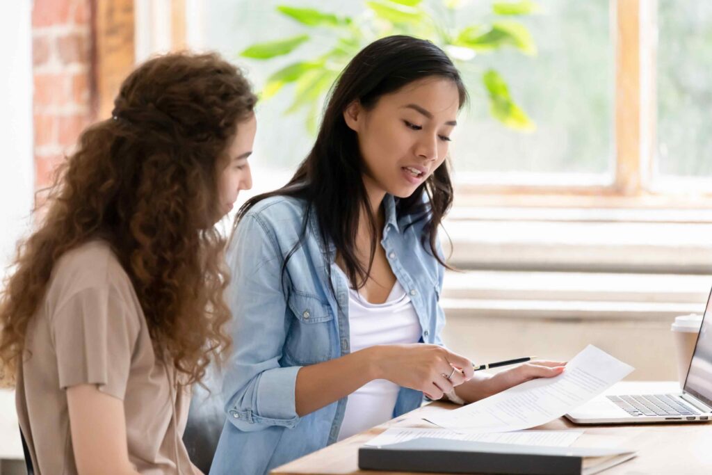 Asian female career advisor showing female college students opportunities for her career