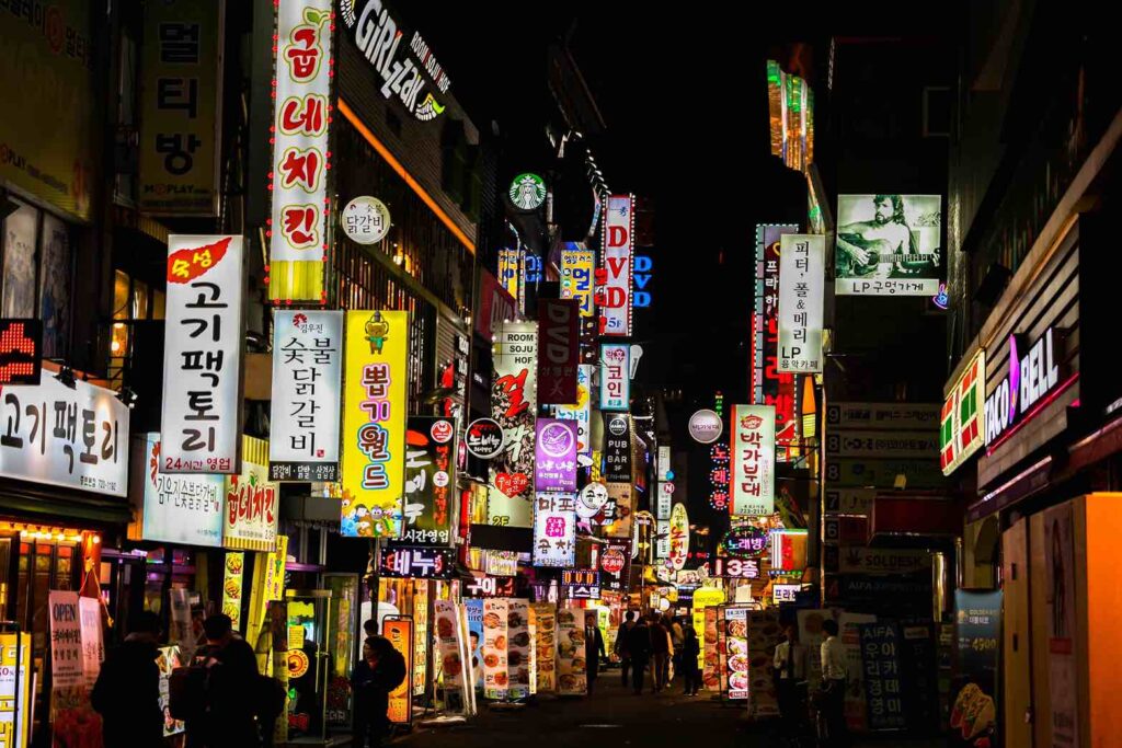 Brightly lit street in Korea with many signs