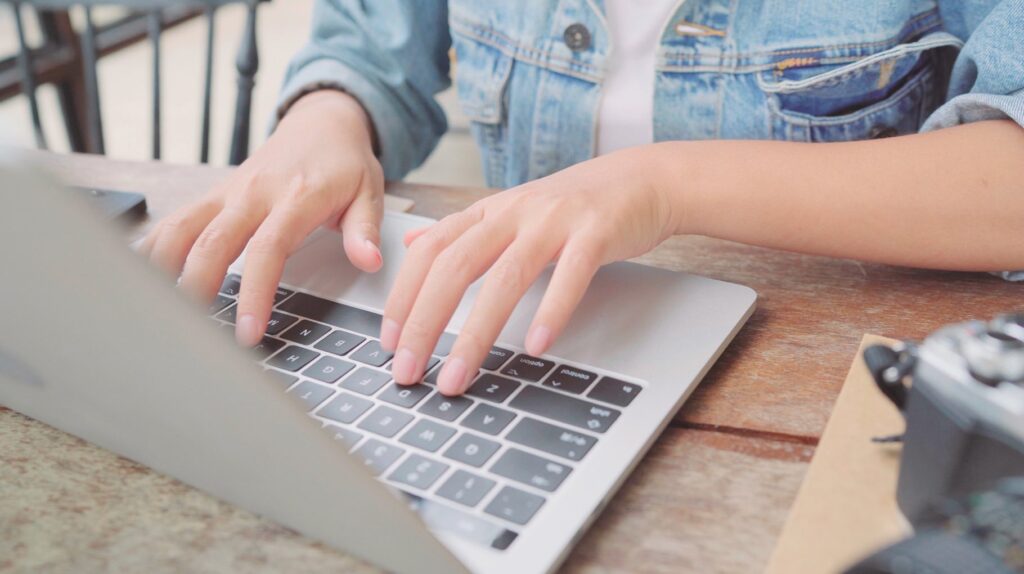 Business freelance asian woman working, doing projects and sending email on laptop or computer while sitting on table in cafe