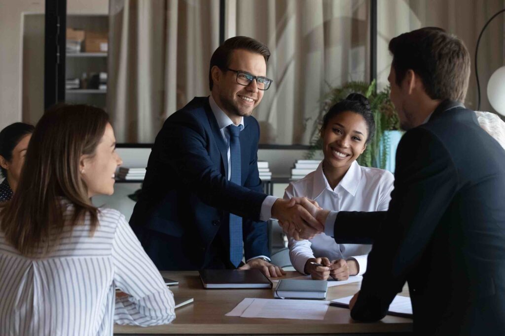 Business meeting with clients where all participants are wearing formal business attire