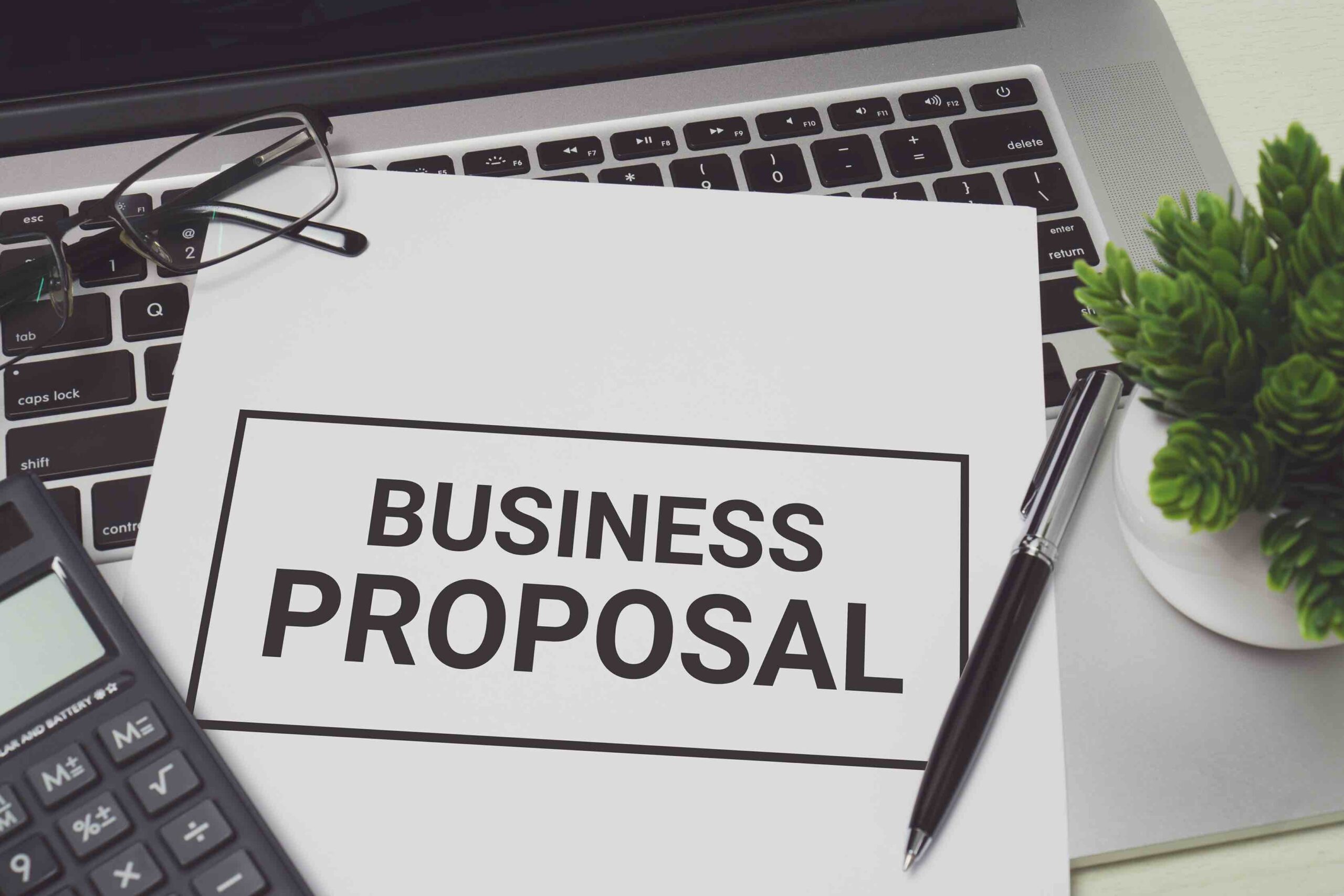 Business proposal on white paper placed on the laptop computer