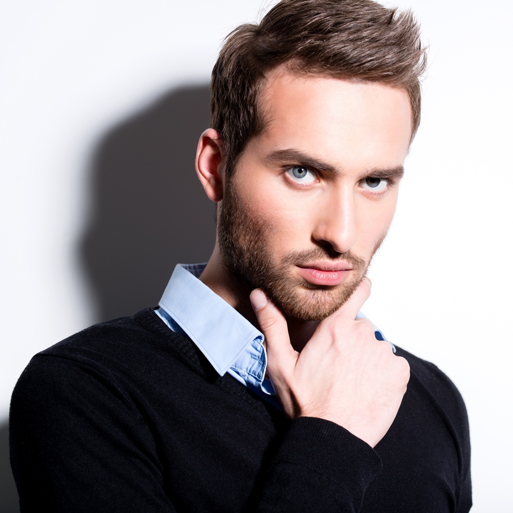 Close-up fashion portrait of young man in black pullover