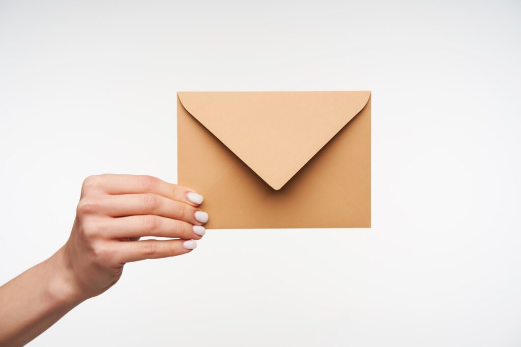 Close up on beautiful hands holding blank envelope of paper