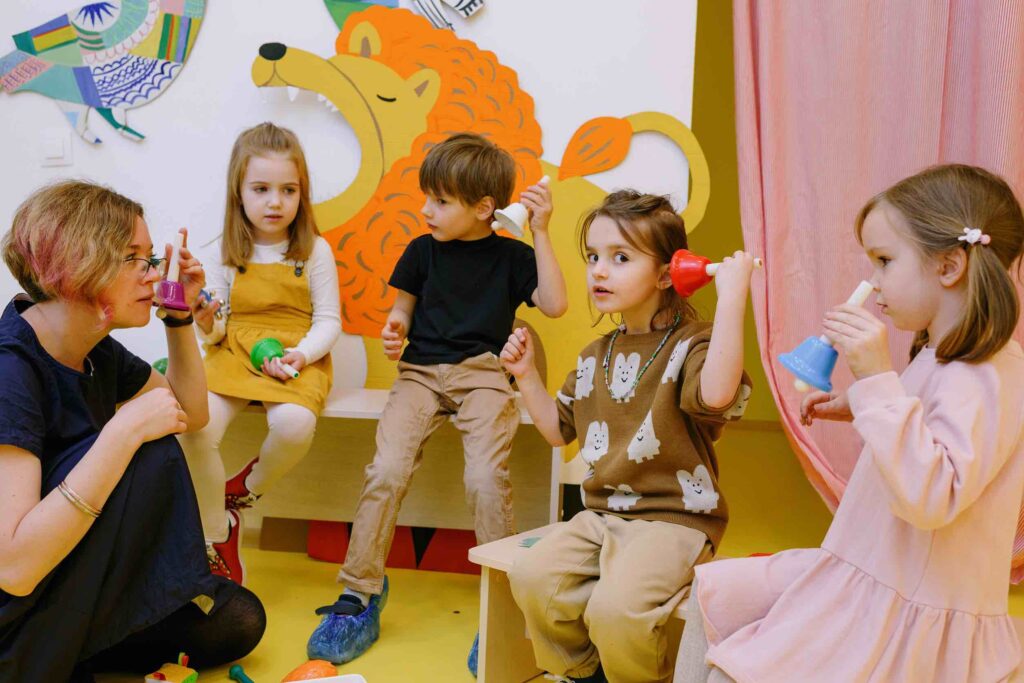 Elementary school teacher playing an educational game with small kids