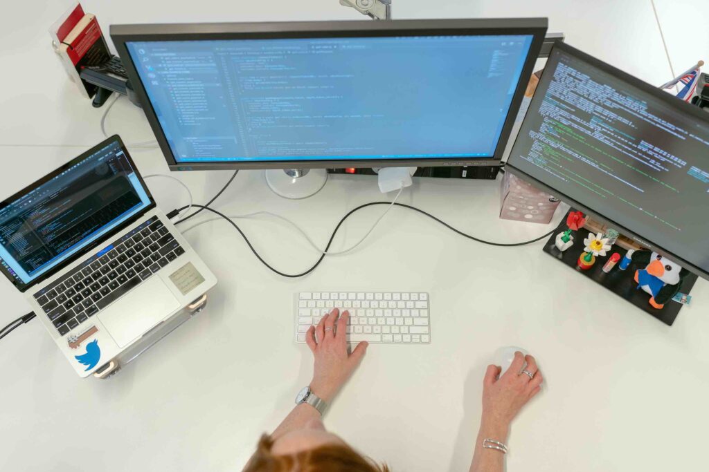 Female Software Engineer Coding On Computer