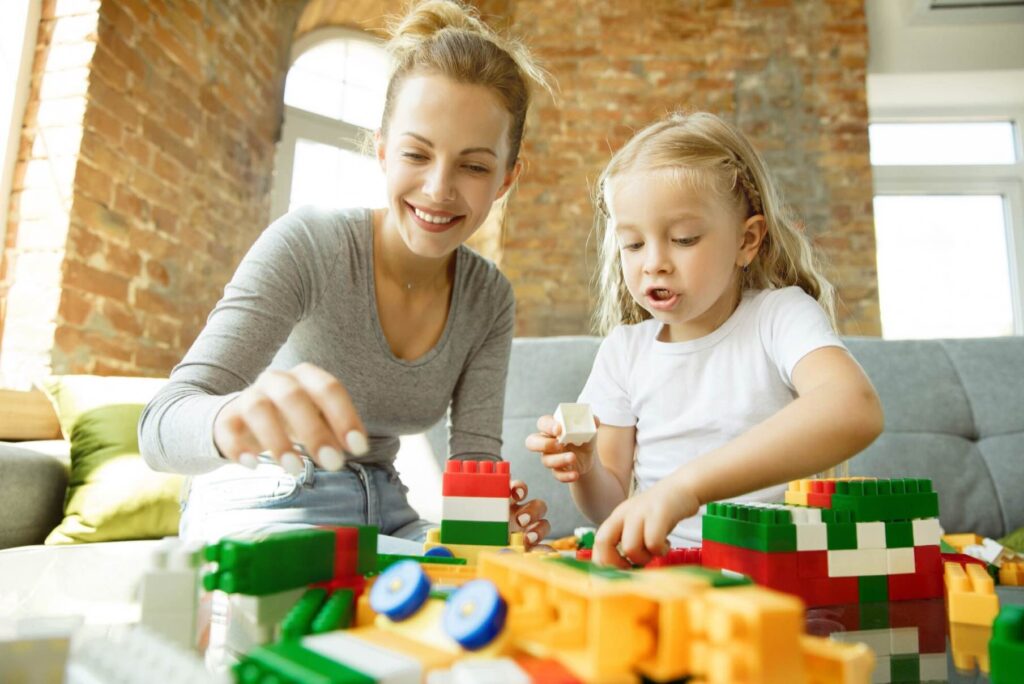 Female caucasian teacher and little girl, or mom and daughter. homeschooling