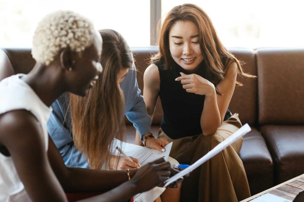 Female coworkers helping each other out with a task