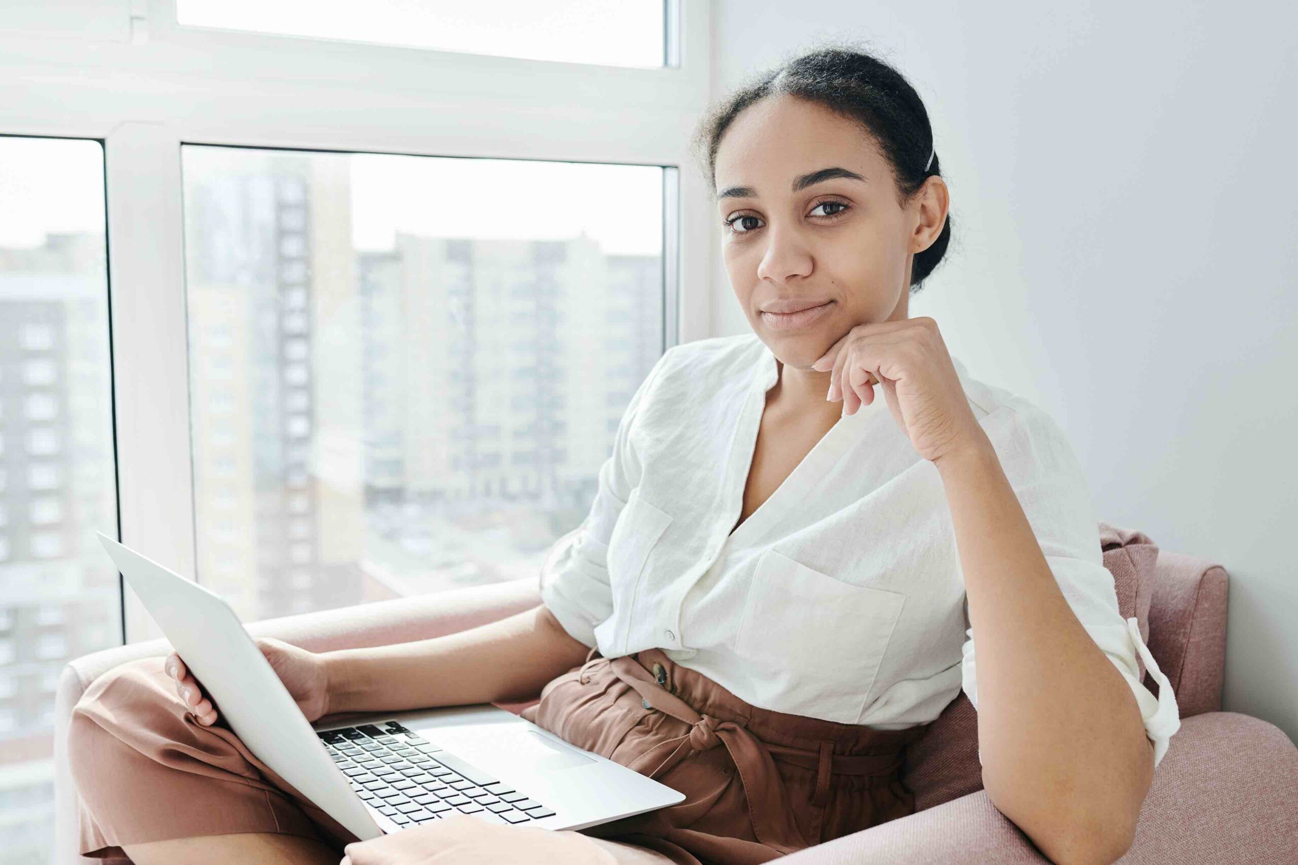 Female job seeker checking out job ads on laptop