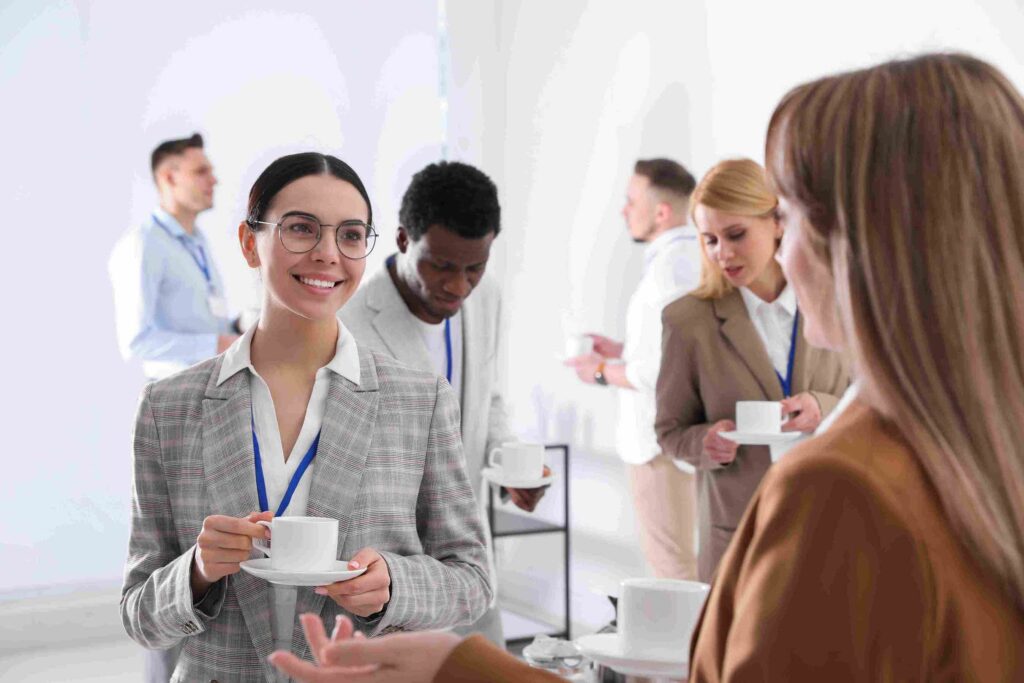 Female young professional networking during an event before applying to her consulting dream job