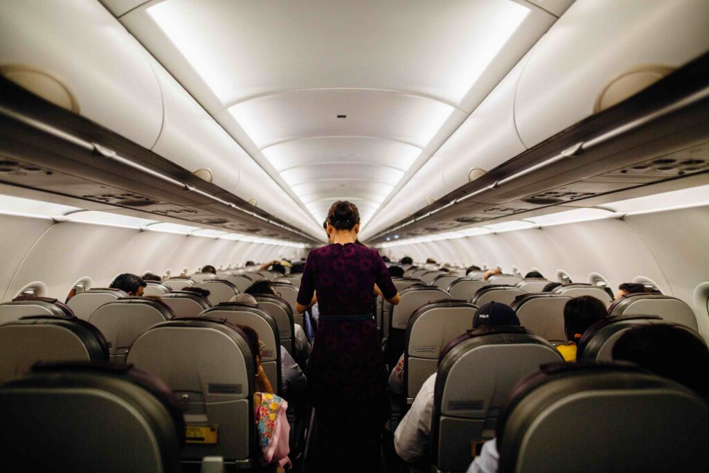 Flight attendants at work serving drinks to passengers
