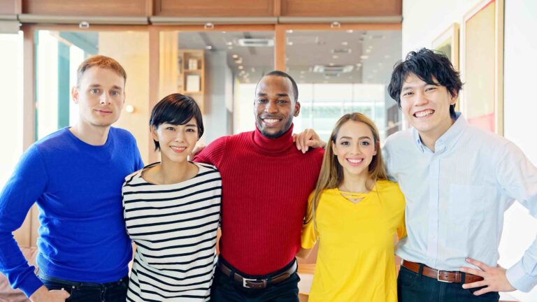 Group of smiling co-workers working at a diverse workplace