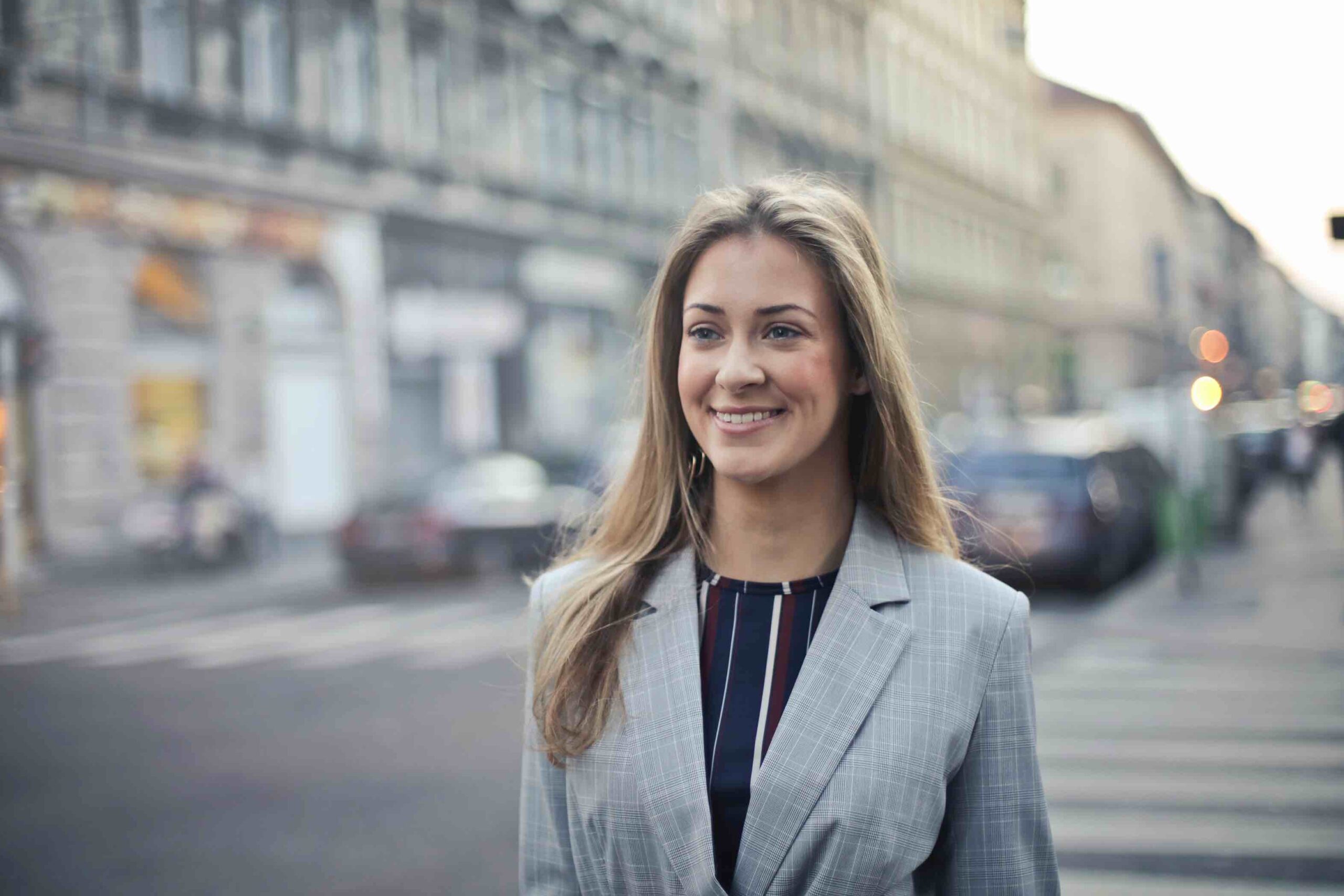 Happy business woman on the street in the city