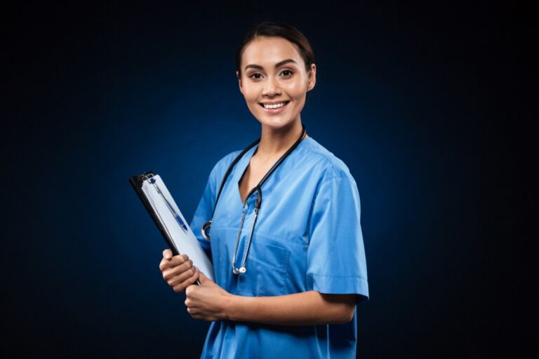 Happy young nurse with clipboard smiling