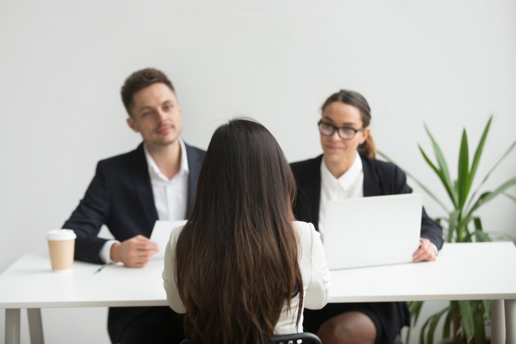 Headhunters interviewing female job candiate