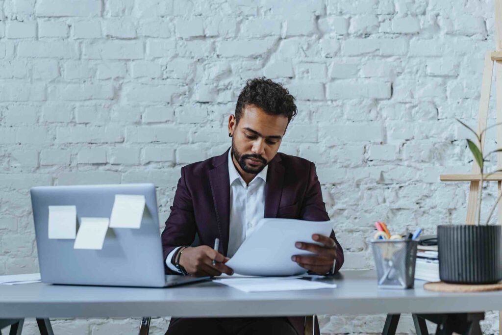 Hiring manager checking out a resume behind his desk