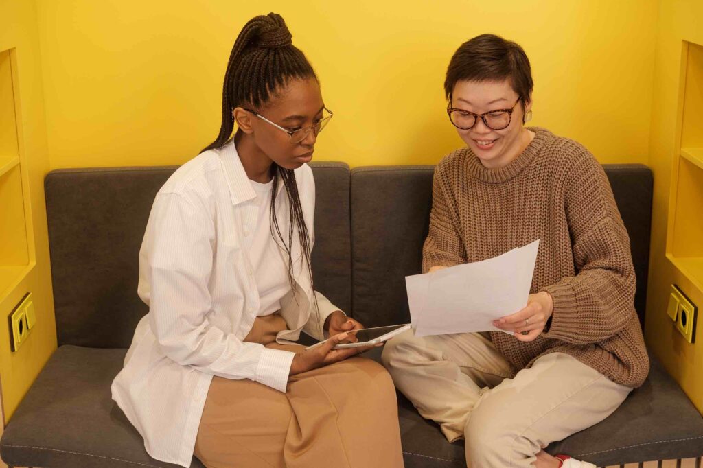 Human resources assistants reviewing applications before hiring managers look at them