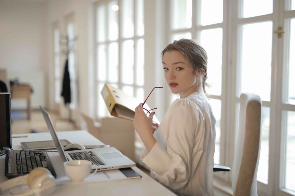 IT administrative assistant at work in the process of putting away folder