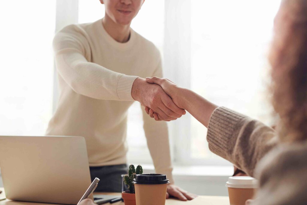 Job applicant invited for an interview shaking the hand of the hiring manager