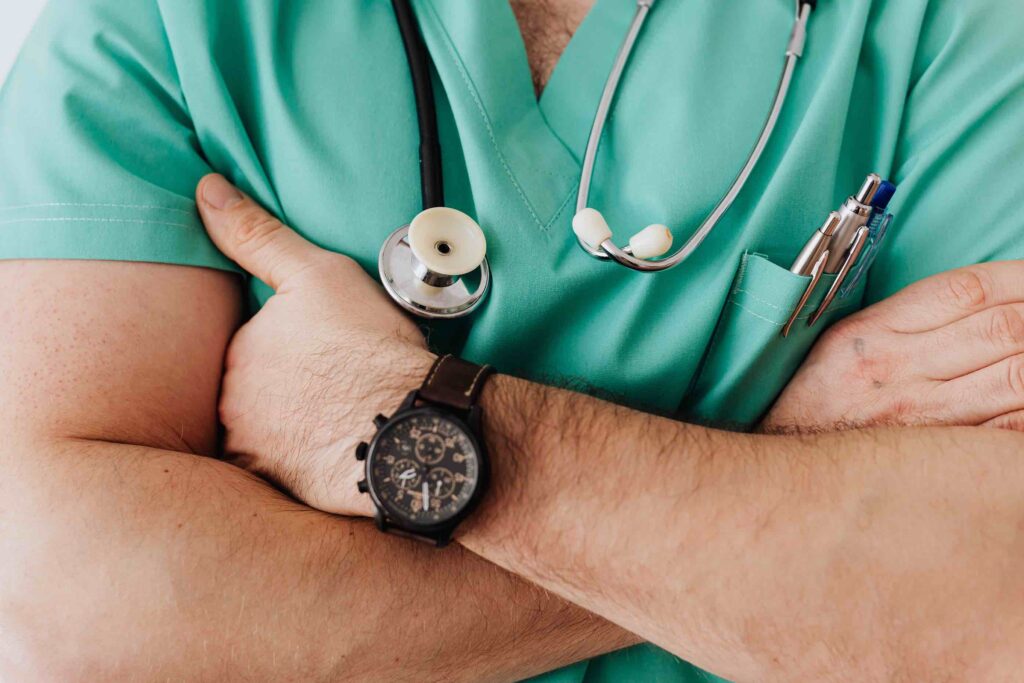 Male medical assistant close up with folded arms