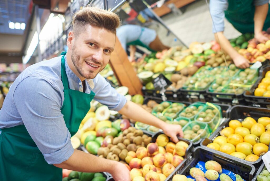 Male retail sales assistant working in supermarket
