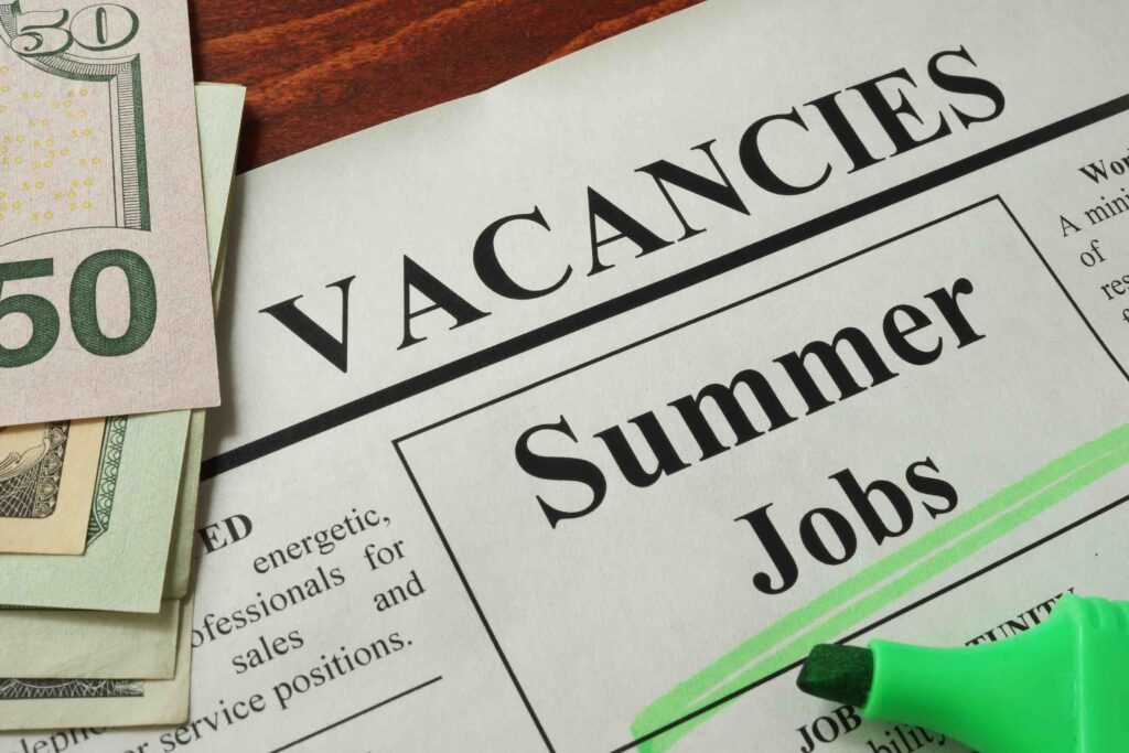 Newspaper with ads summer jobs vacant.