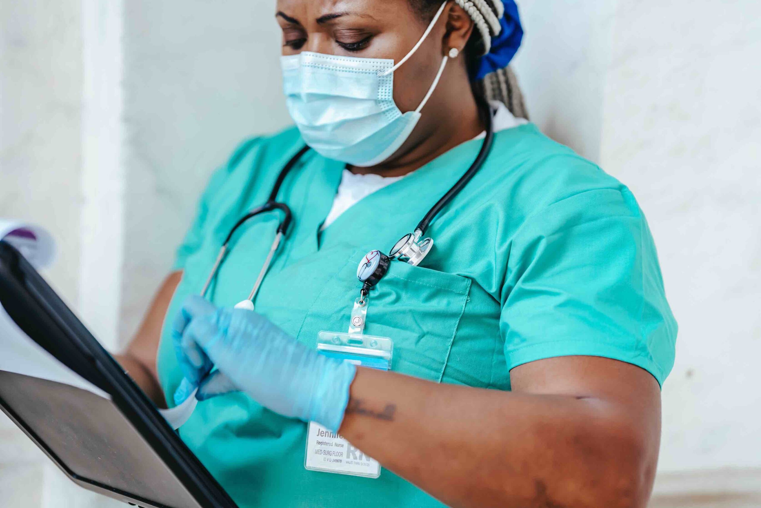 Certified nursing assistant at work checking clipboard