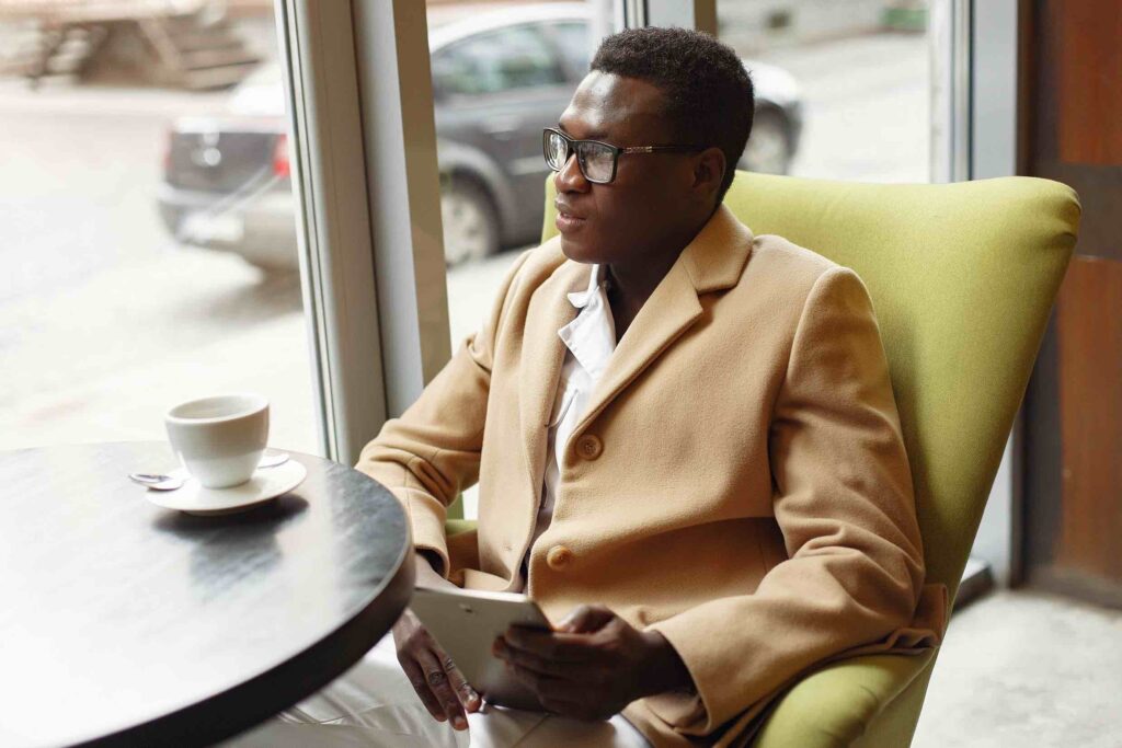 Pensive businessman in cafe thinking about his career goals