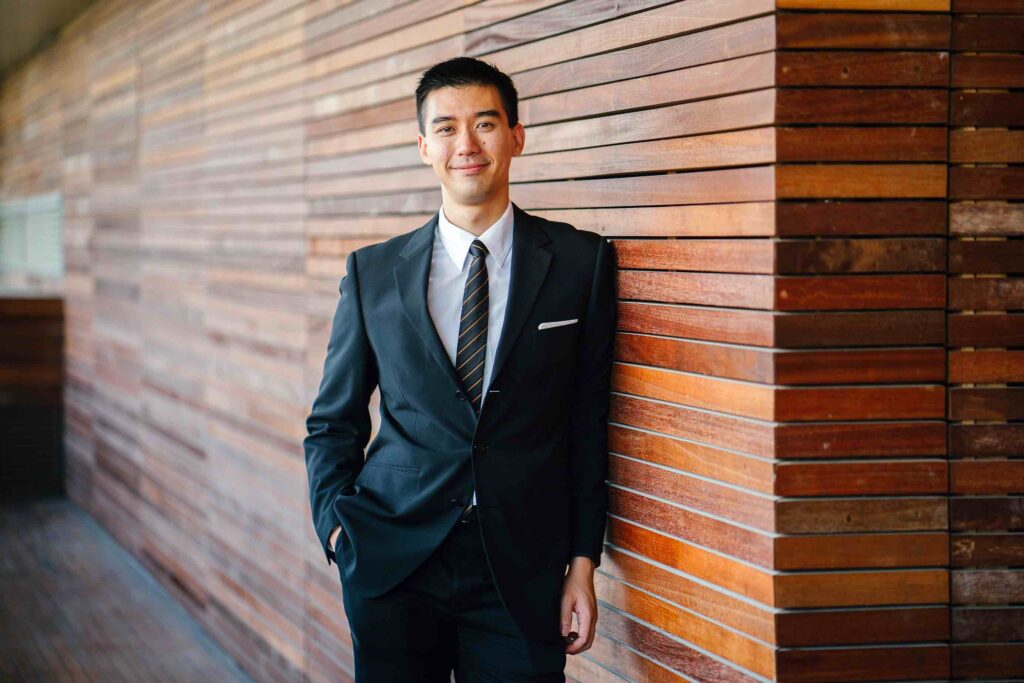 Professional marketing specialist in suit smiling into camera