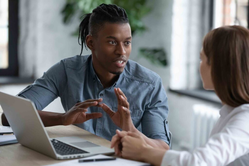 Recent male graduate talking to a female student about the best career advice for college students