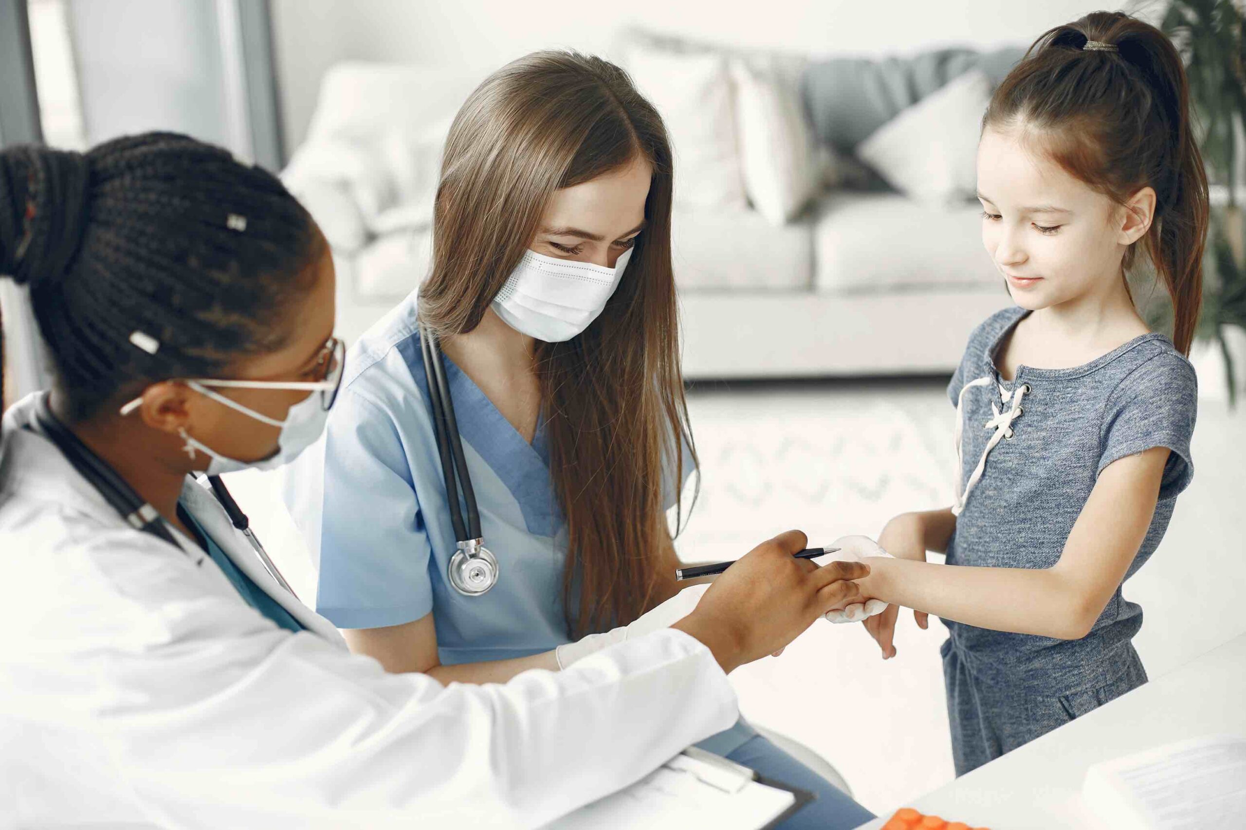 Registered nurse and doctor examining young girl