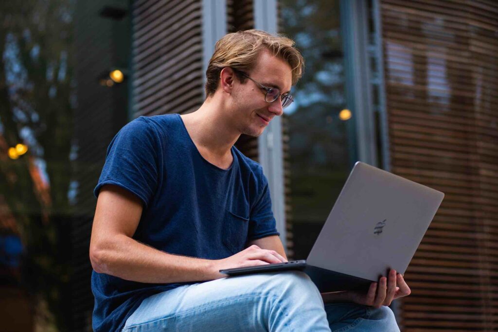 Smiling college student in front of laptop