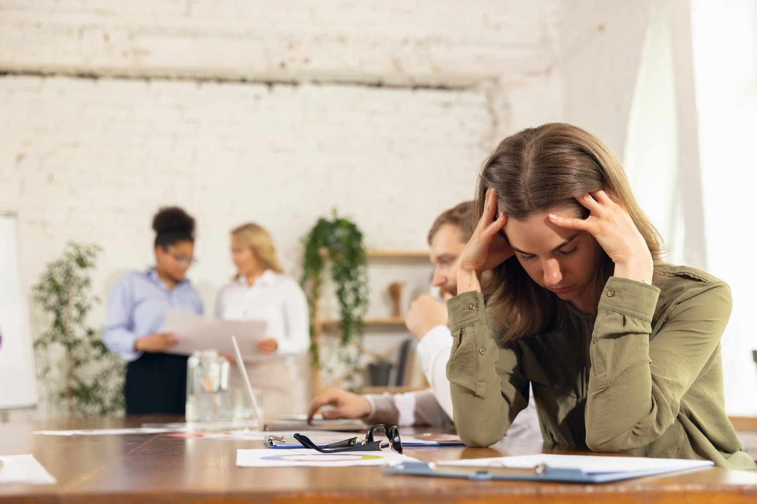 Stressed employee in office because she is grieving a loss