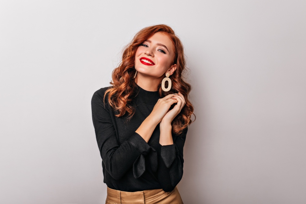 Stylish woman in black blouse smiling