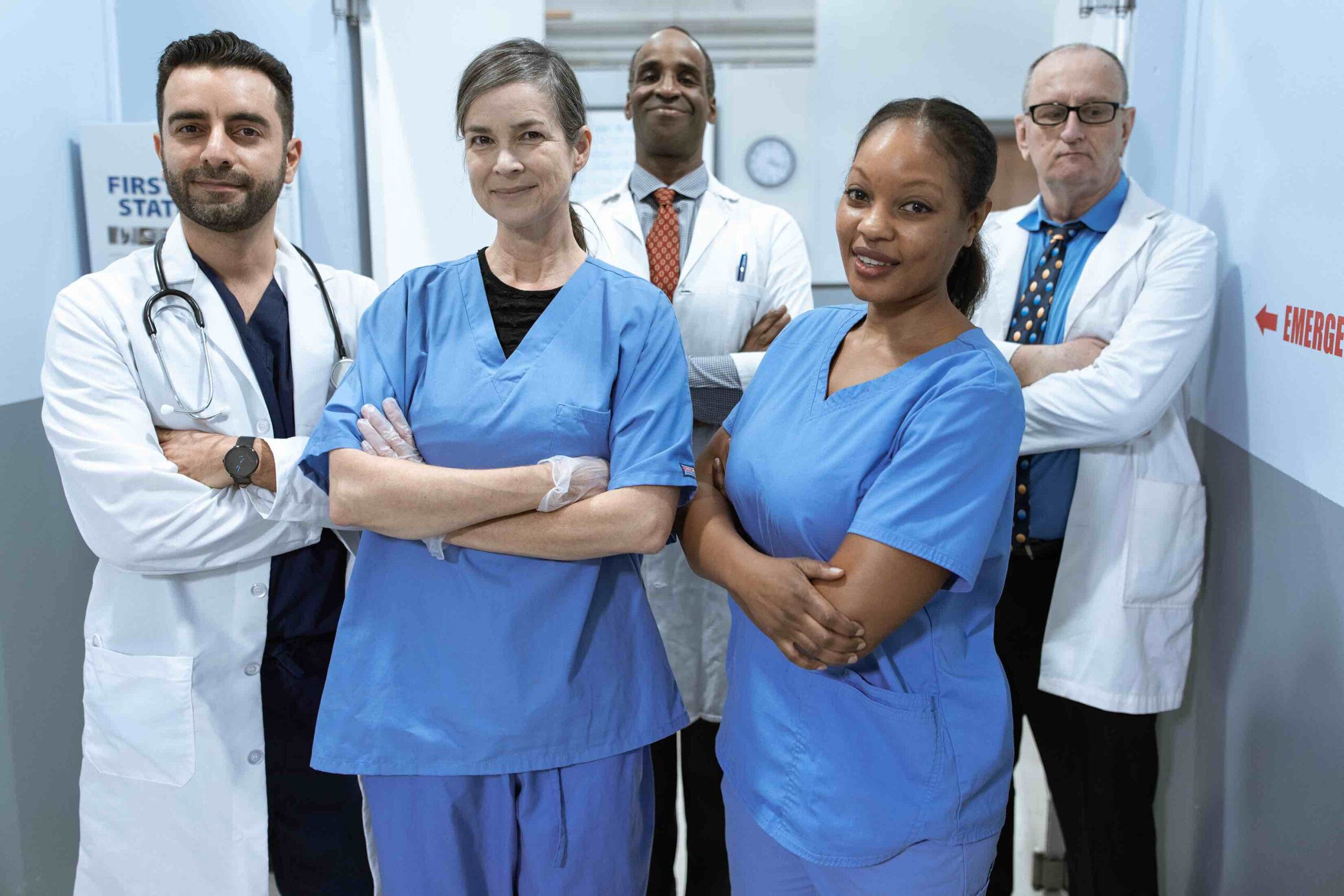 Team of nursing professionals in hospital corridor