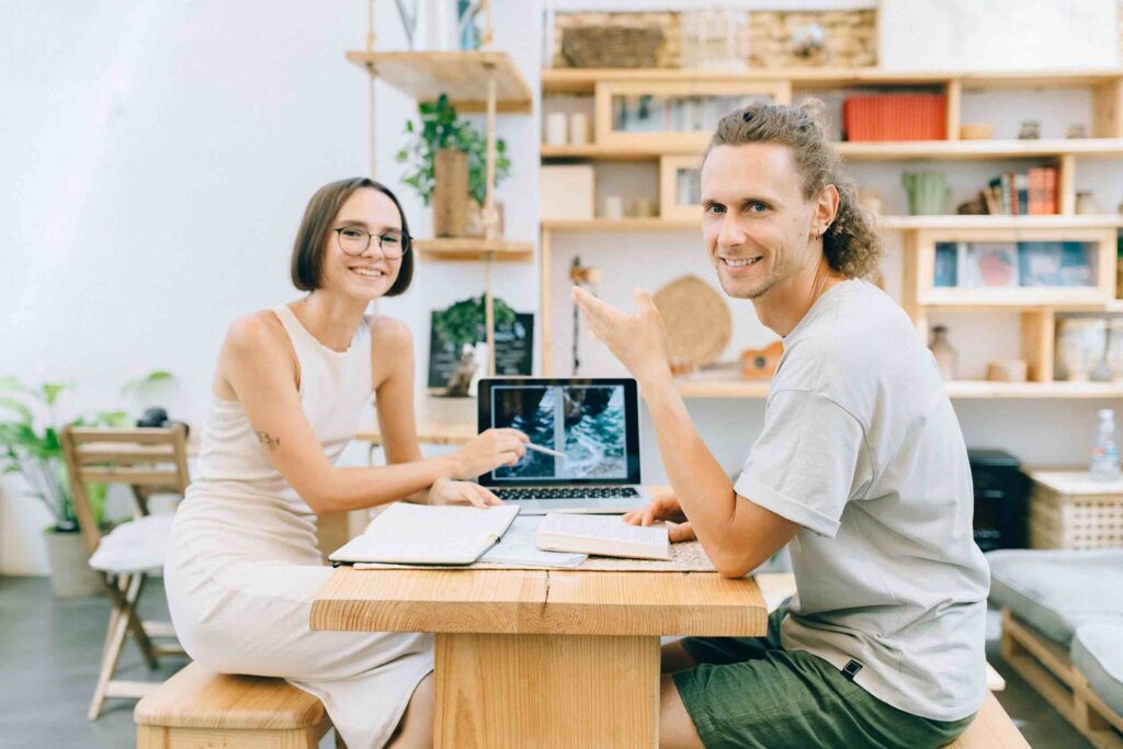 Two colleagues are happily chatting about their career trajectory during a performance review