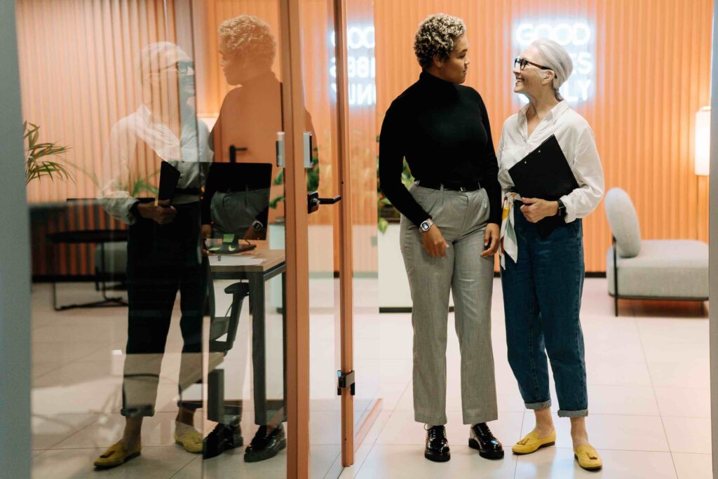 Two employees talking to each other, showing their soft skills like communication