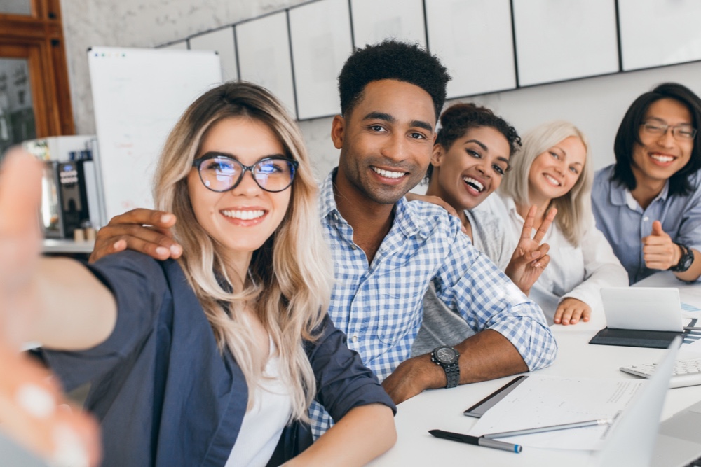 Happy coworkers in office space with great people skills