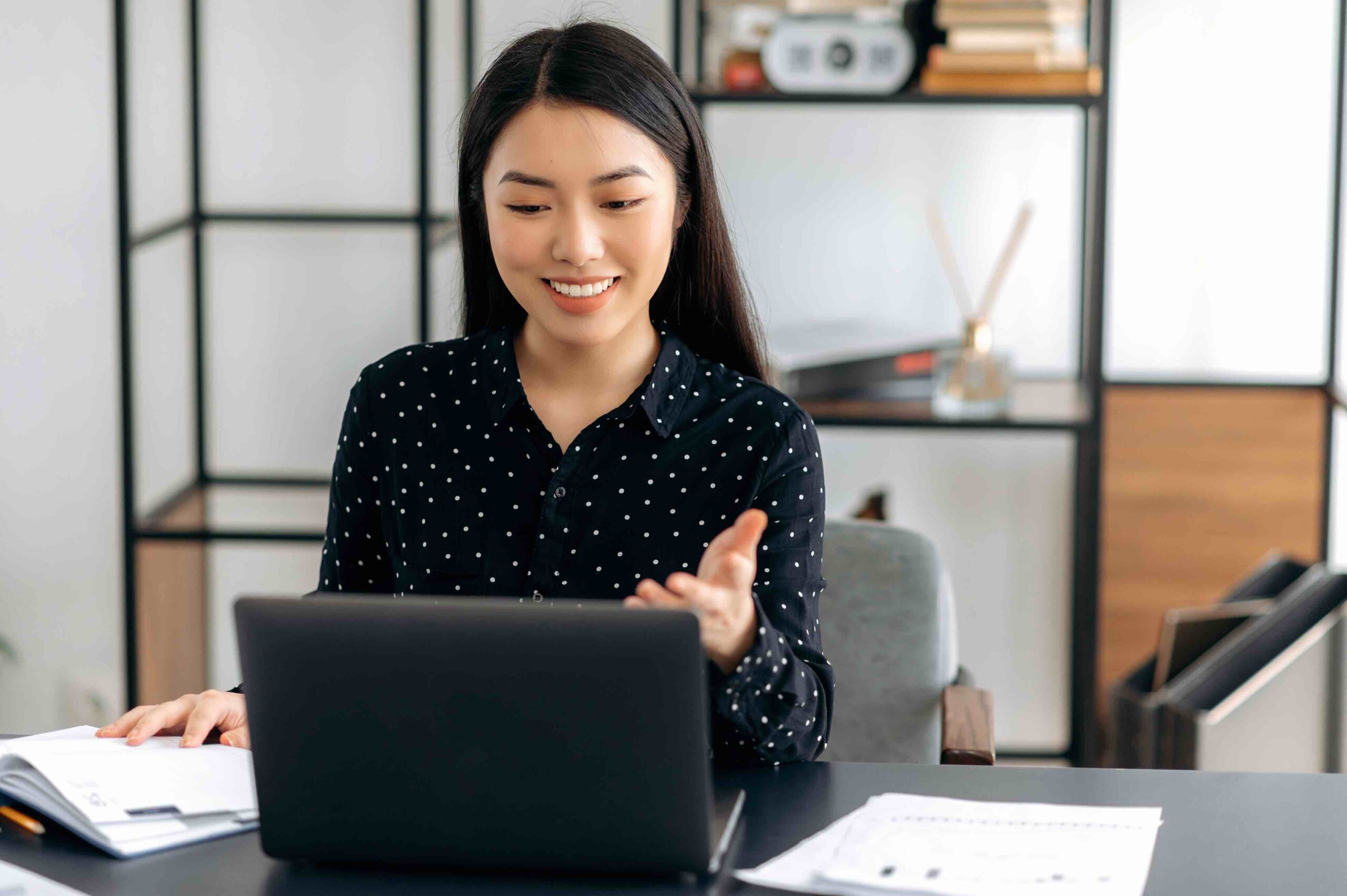 Charismatic and highly-skilled manager in remote office chatting with her team members