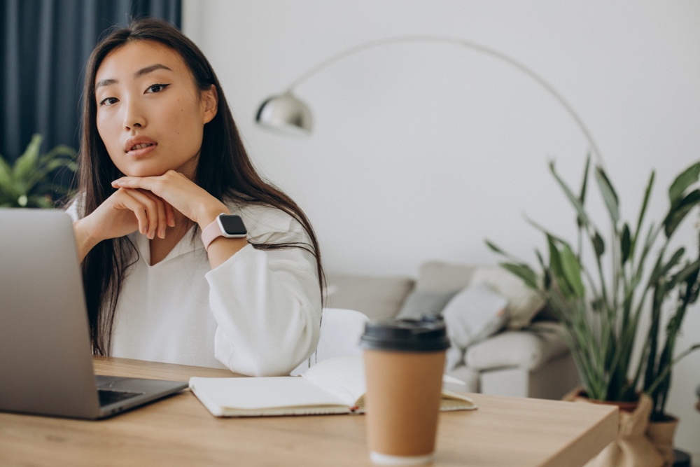 Woman working on computer at the desk from home