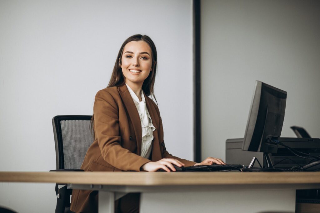 Young business woman working on laptop in office