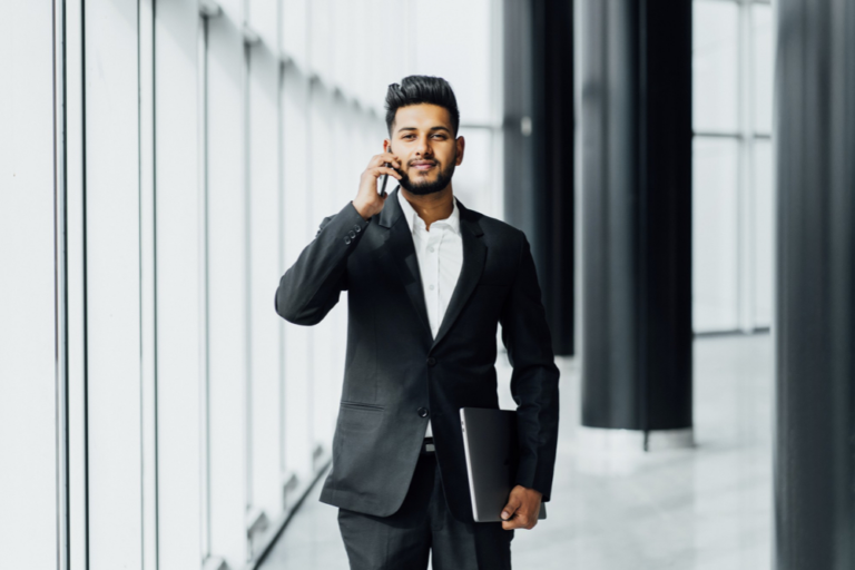 Young businessman in suit answering call about salary expectations