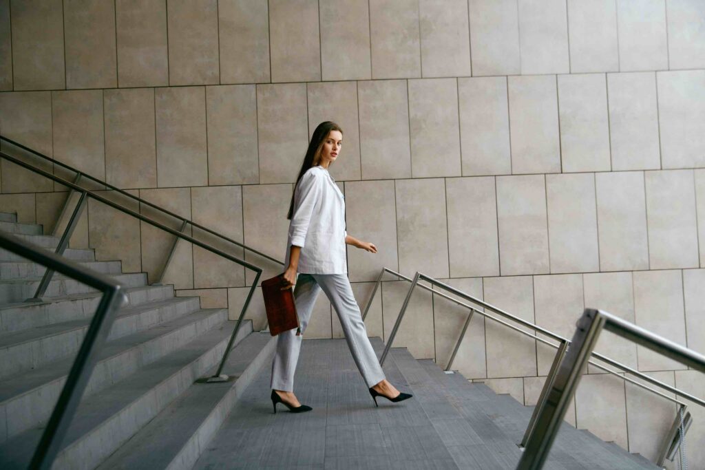 Young employee walking down the stairs in professional business attire