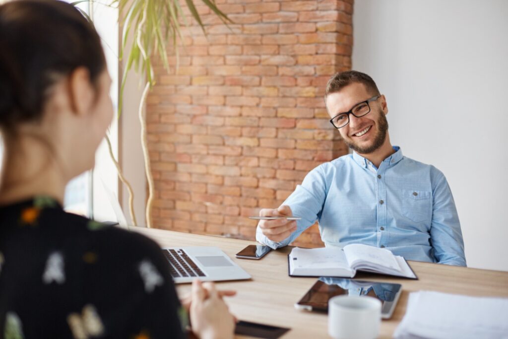 Young job applicant talking to the hiring manager regarding an internship position and answering his interview questions