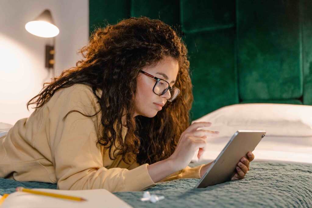 Young job seeker drafting her career change cover letter on her tablet