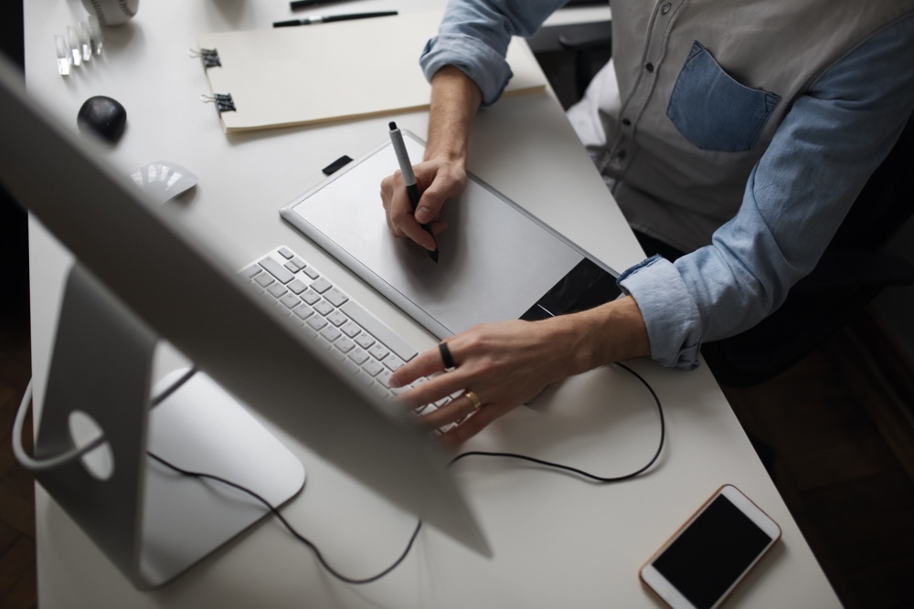 Young male designer using graphics tablet